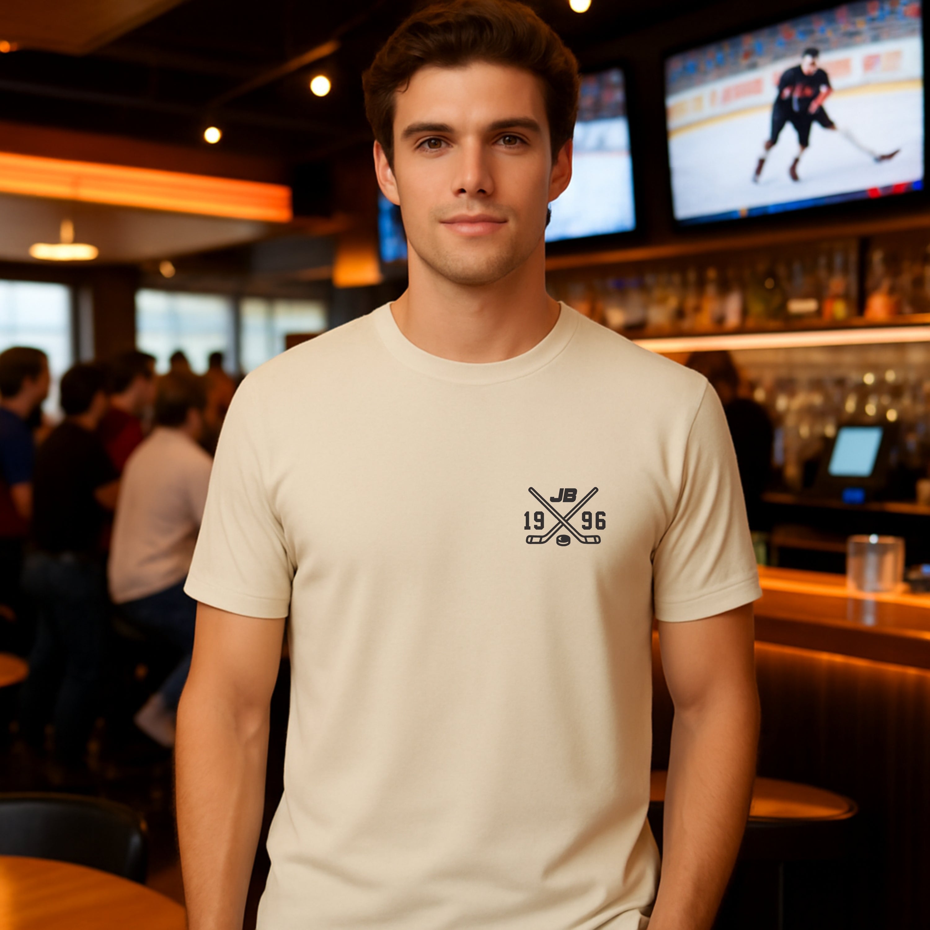 Beige T-shirt, ice hockey stick cross